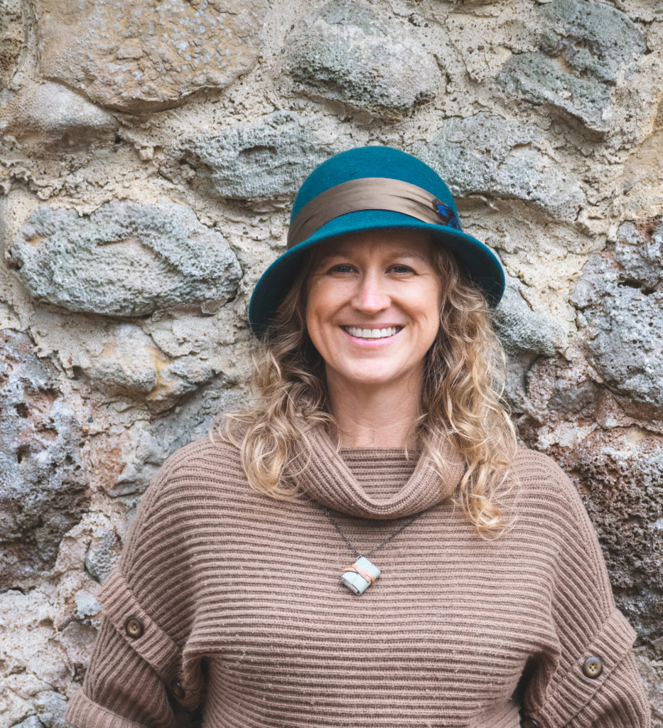 A woman poses with a bright blue hat.