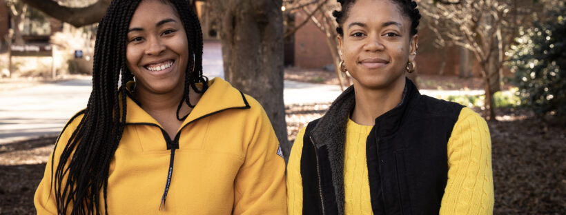 Two women stand outside in yellow.