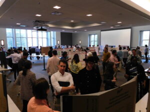 Attendees look at research posters at the Confluence poster event.