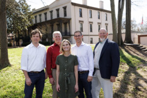2024 Team Impact Award winners Scott Pippin, Brian Bledsoe, Shana Jones, Don Nelson and Mark Risse of the Carl Vinson Institute of Government in front of the Lucy Cobb Complex.