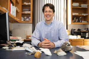Jeb Byers at a desk with shells.
