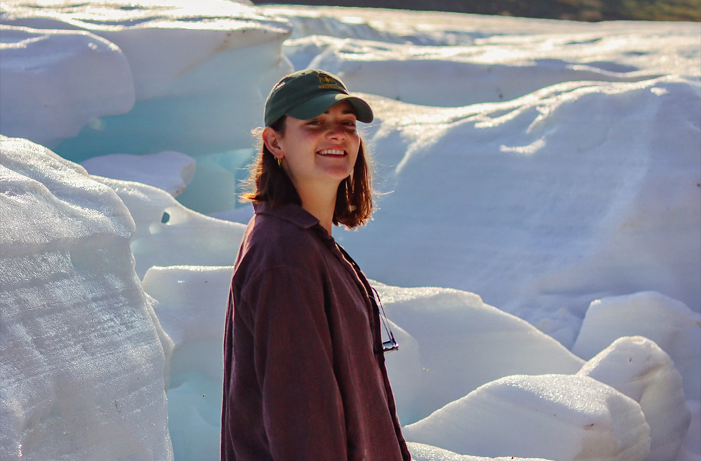 Annie Blalock stands in front of a glacier in Alaska.