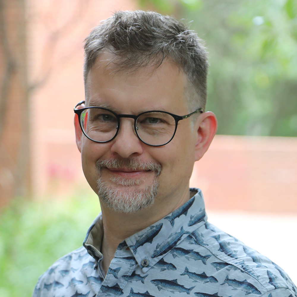 Headshot of Seth Wenger in front of the Odum School of Ecology.
