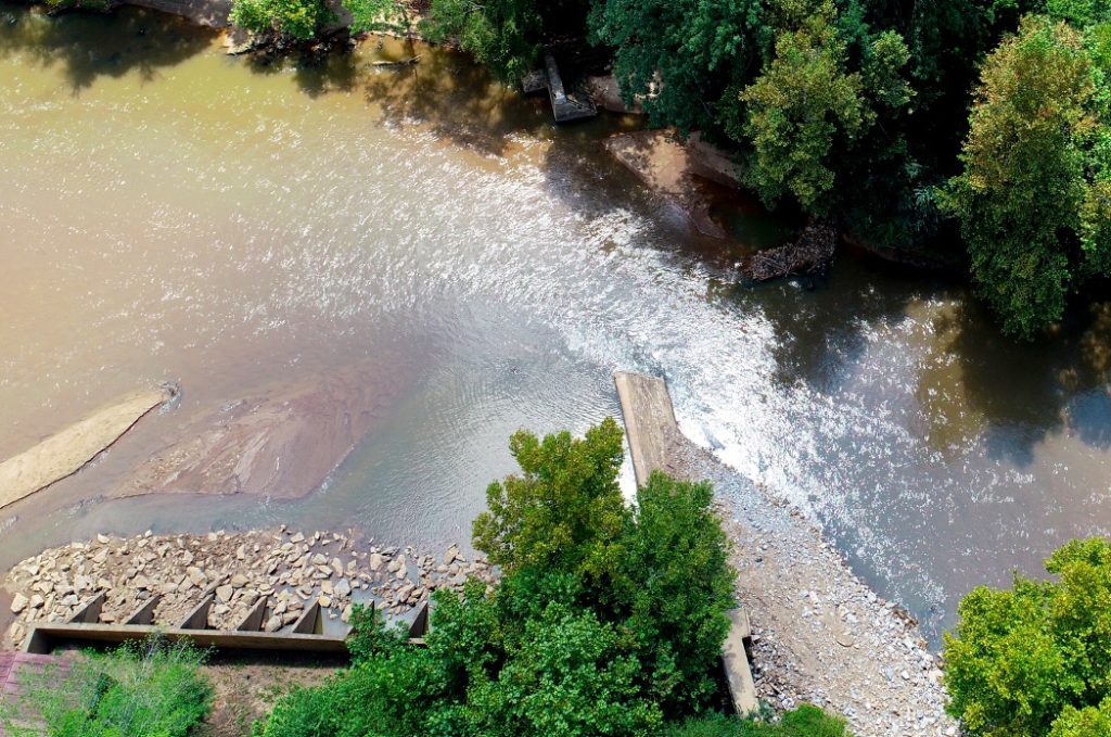 An aerial photo of a stream where a dam has been partially removed